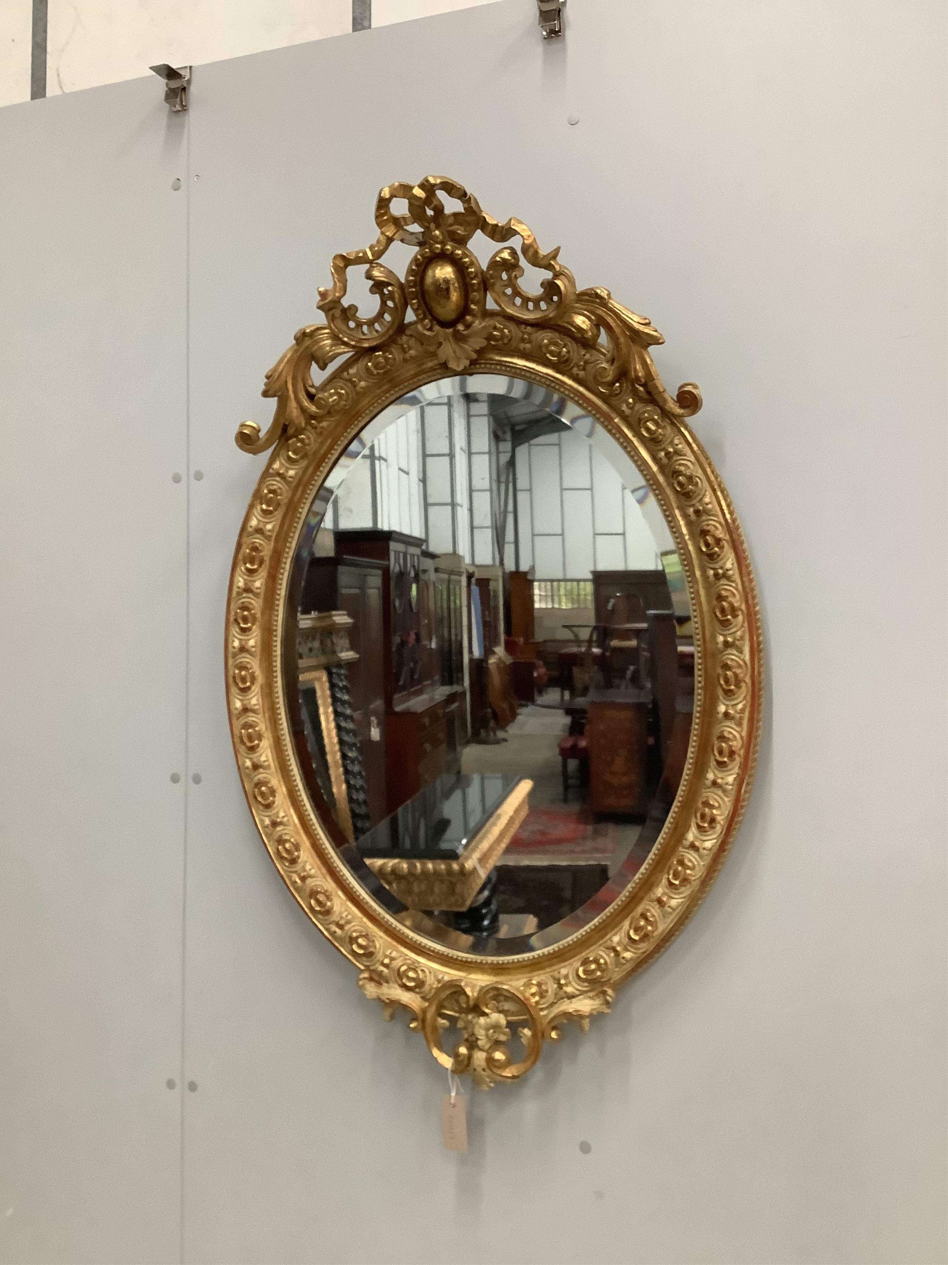 A 19th century French giltwood and gesso wall mirror, width 73cm, height 112cm. Condition - fair, some small losses to the upper crest